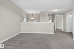 Carpeted interior space featuring light gray walls and white trim - 