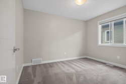 Neutral-toned walls complement the grey carpet flooring - 