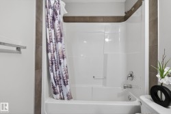 White bath and shower combination with chrome fixtures - 