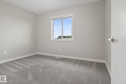 Neutral gray walls complement the patterned gray carpeting in this room - 