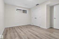 Light-toned wood-finish flooring complements the neutral wall color and white trim - 