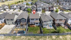 Rear exterior featuring a spacious backyard, a multi-level deck, and a shed - 