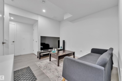 Bright interior space featuring light wood-finish flooring, recessed lighting, and white walls - 2630 16A Avenue, Edmonton, AB 