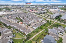 Aerial view featuring a residential development of townhomes and detached properties - 