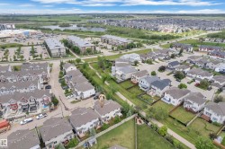 Aerial perspective showcasing the residential neighborhood layout with a mix of detached homes and townhouses - 
