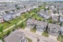 Aerial perspective of a contemporary residential neighborhood featuring uniform roofing and established landscaping - 24 655 Tamarck Road, Edmonton, AB 