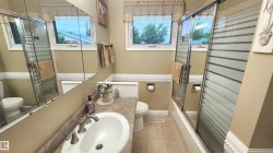 Bathroom featuring a single vanity with a white basin sink, brushed nickel faucet, and a patterned countertop - 