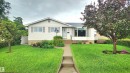 White siding exterior with a prominent bay window - 13307 Delwood Road, Edmonton, AB 