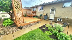 Outdoor living space featuring a wood-finish deck with privacy lattice - 