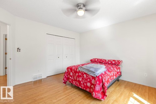 Bedroom featuring wood-finish flooring, white walls, and a ceiling fan with integrated lighting - 44 9630 176 Street, Edmonton, AB 