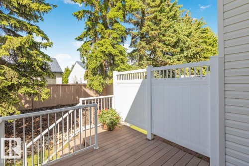 Outdoor deck featuring wood-finish flooring, white railing, and a privacy wall - 44 9630 176 Street, Edmonton, AB 