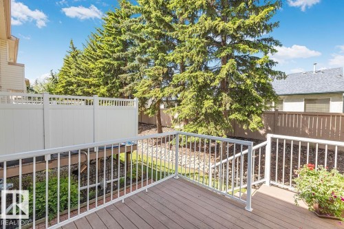 Wood-finish decking with white railings and privacy fencing - 44 9630 176 Street, Edmonton, AB 