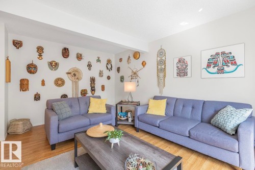 Bright living area featuring wood-finish flooring, white walls, and recessed lighting - 44 9630 176 Street, Edmonton, AB 