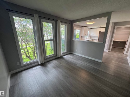 Interior space featuring wood-finish flooring and light gray painted walls - 6441 180 Street, Edmonton, AB 