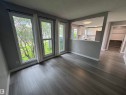 Interior space featuring wood-finish flooring and light gray painted walls - 6441 180 Street, Edmonton, AB 
