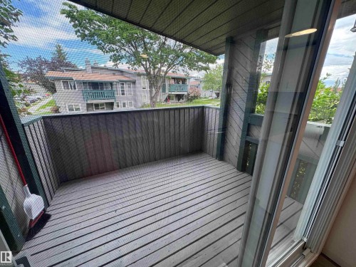 Private outdoor balcony featuring wood-finish decking and vertical wood paneling - 6441 180 Street, Edmonton, AB 