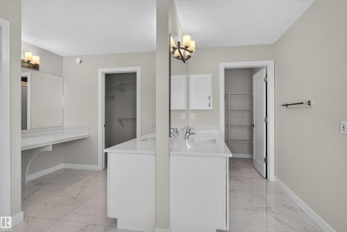 Dual sink vanity with white cabinetry and quartz countertops - 9432 229 Street, Edmonton, AB 