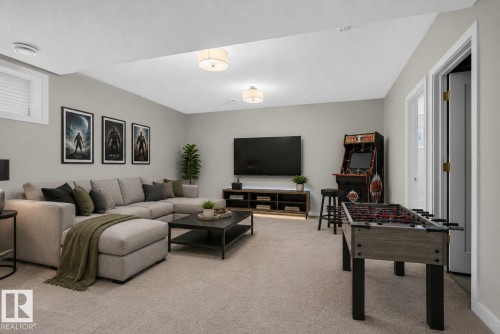Spacious recreational area featuring recessed lighting, light gray wall paint, and neutral carpeting - 9432 229 Street, Edmonton, AB 
