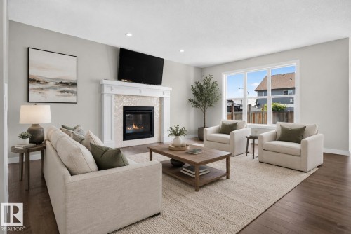 Living area featuring a gas fireplace with a decorative tile surround and white wood mantel - 9432 229 Street, Edmonton, AB 