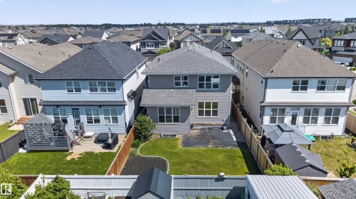 Contemporary two-story residence featuring a private backyard with a manicured lawn and a concrete patio - 9432 229 Street, Edmonton, AB 