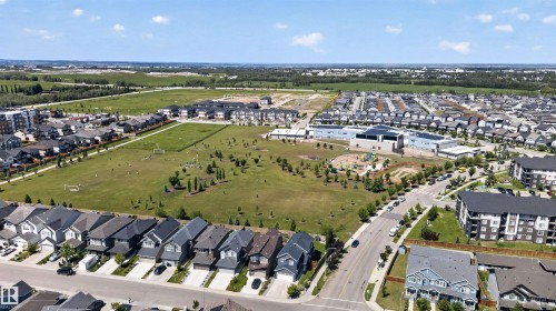 Aerial perspective of a developed community with single-family residences and apartment buildings - 9432 229 Street, Edmonton, AB 