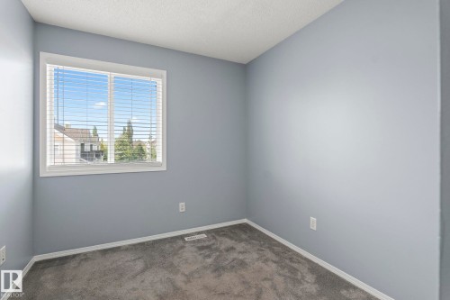 Interior space featuring light gray walls, white trim, and gray carpet - 7118 19A, Edmonton, AB - Indoor Photo Showing Other Room