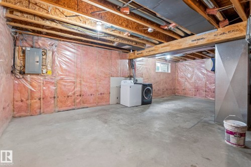 Unfinished basement featuring exposed wood joists, concrete flooring, and insulated walls - 7118 19A, Edmonton, AB - Indoor Photo Showing Basement