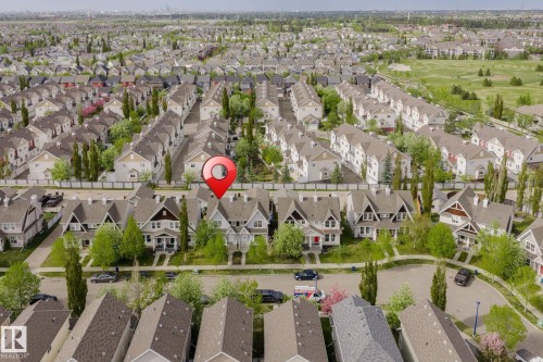 Aerial view of a residential neighborhood with numerous detached homes, mature trees, and a curvilinear street layout - 7118 19A, Edmonton, AB - Outdoor With View