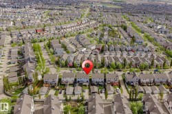 Aerial perspective showcasing a residential neighborhood with numerous detached homes - 