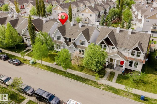 Exterior featuring a light-colored facade with dark brown gables, a prominent front porch with white columns, and multiple windows - 7118 19A, Edmonton, AB - Outdoor