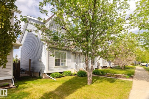 Front exterior featuring light gray horizontal siding and white trim - 7118 19A, Edmonton, AB - Outdoor