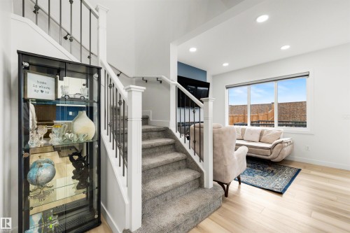 Carpeted staircase with white balusters and dark metal spindles - 3173 Checknita Way, Edmonton, AB 