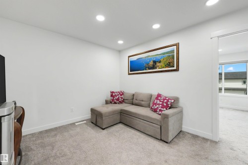 Carpeted interior space featuring recessed lighting, white walls, and white baseboards - 3173 Checknita Way, Edmonton, AB 
