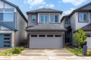 Two-story residence featuring a dark gray shingled roof and light gray siding - 3173 Checknita Way, Edmonton, AB 