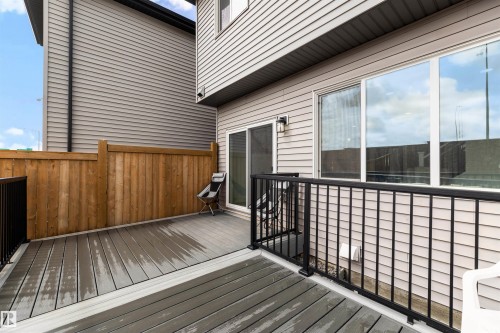 Spacious composite deck featuring dark gray decking and black metal railings - 3173 Checknita Way, Edmonton, AB 