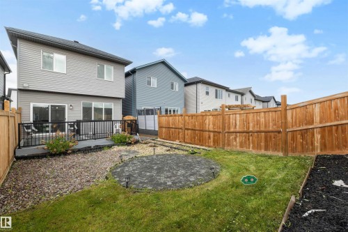 Rear exterior featuring gray siding and a dark gray roof - 3173 Checknita Way, Edmonton, AB 