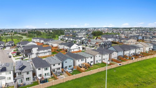 Expansive aerial showcasing a modern residential development with a variety of contemporary homes - 3173 Checknita Way, Edmonton, AB 