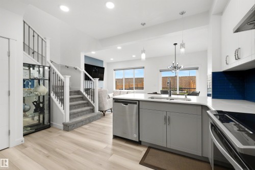 Open-concept living space with light wood-finish flooring - 3173 Checknita Way, Edmonton, AB 
