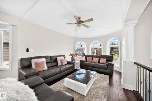 Living area featuring a vaulted ceiling and dark wood-finish flooring - 16124 76 Street, Edmonton, AB 