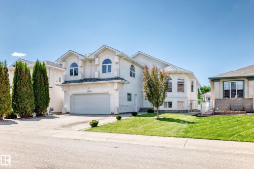 Stucco exterior with multiple gables and arched windows - 16124 76 Street, Edmonton, AB 