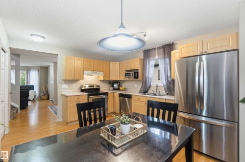 Kitchen with wood-finish flooring and light wood cabinetry - 3117 32 Avenue, Edmonton, AB 