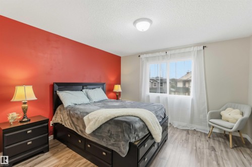 Bedroom with a single window, a flush-mount ceiling light, and wood-finish flooring - 3117 32 Avenue, Edmonton, AB 