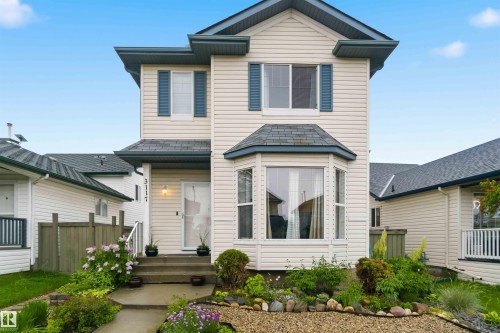 Two-story residence featuring light-colored siding and a dark shingle roof - 3117 32 Avenue, Edmonton, AB 