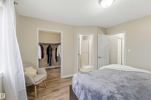 Room featuring wood-finish flooring, a built-in closet, and light neutral wall paint - 3117 32 Avenue, Edmonton, AB 