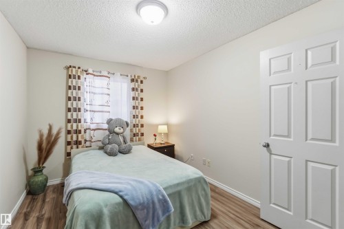 Interior room featuring wood-finish flooring and light-toned walls - 3117 32 Avenue, Edmonton, AB 