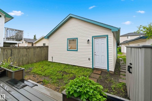 Detached auxiliary building with siding exterior, a single entry door, and a small window - 3117 32 Avenue, Edmonton, AB 