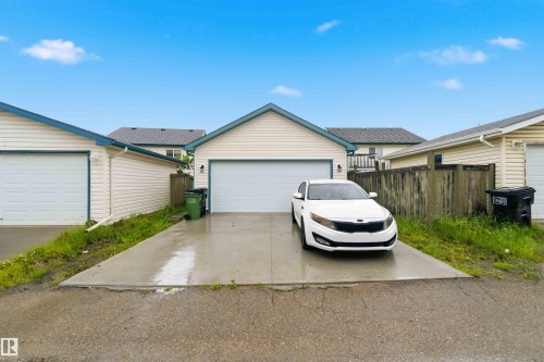 Detached garage with a light-toned exterior siding and a white garage door - 3117 32 Avenue, Edmonton, AB 
