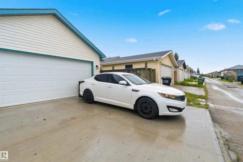 Detached two-car garage with white panel doors and light-colored siding - 3117 32 Avenue, Edmonton, AB 