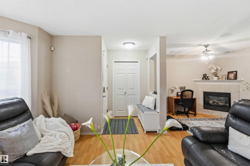 Entryway with wood-finish flooring, a white paneled door, and a built-in storage bench - 3117 32 Avenue, Edmonton, AB 