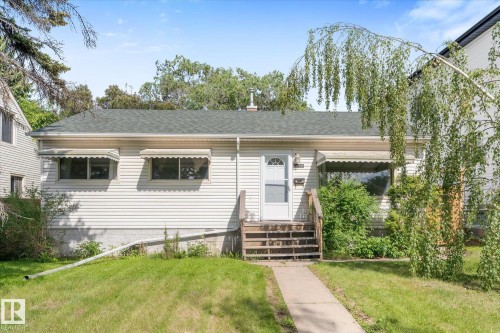 Single-story residence featuring light-colored siding and a dark shingle roof - 9315 86 Street, Edmonton, AB 
